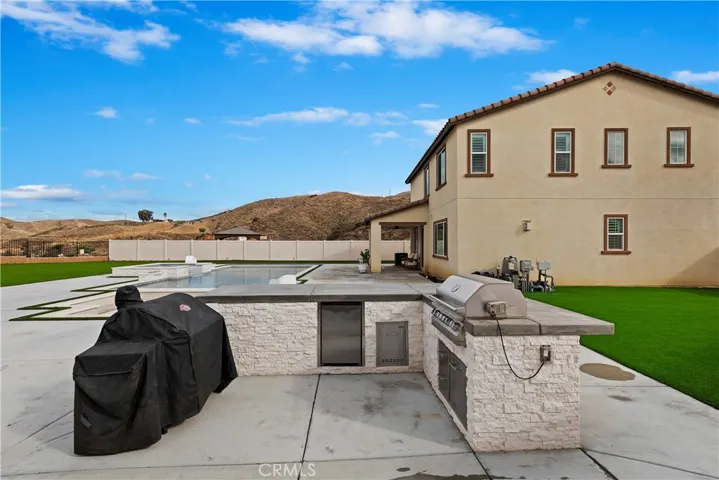 BBQ island with extra electrical outlets and refrigerator