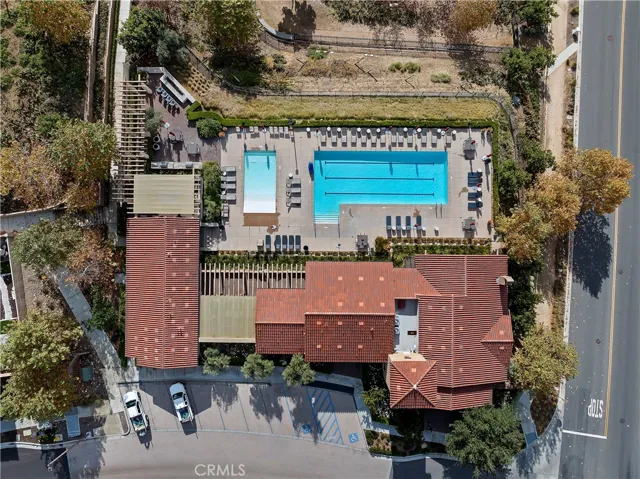 Aerial view of clubhouse with lap pool and seating areas