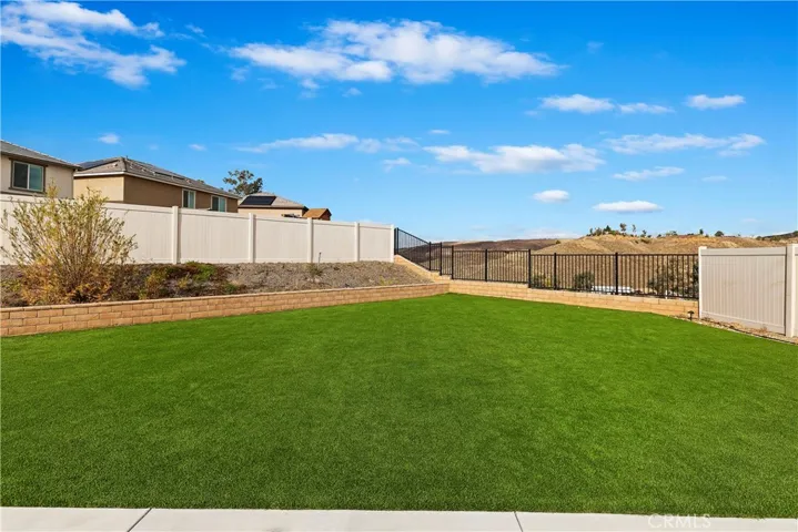 Expansive turf area in backyard with hill views