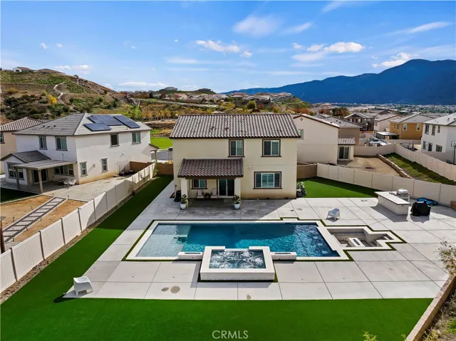 Low maintenance yard with turf and beautiful pool, spa & firepit