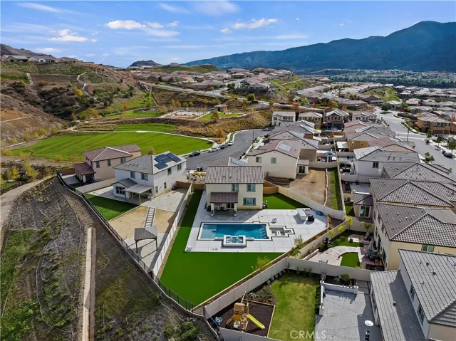 The home is adjacent to the grassy park and basketball courts