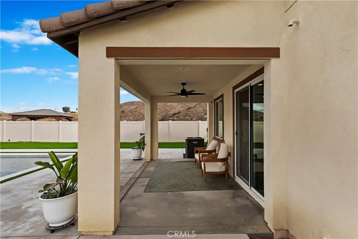 Covered patio with ceiling fan and speakers