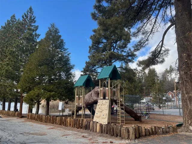 A park for the kids. Behind you can see the sandy beach and the lake.