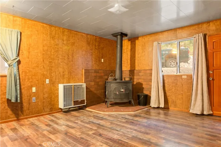 Cozy living room with wood burning stove. Check out the newer flooring.