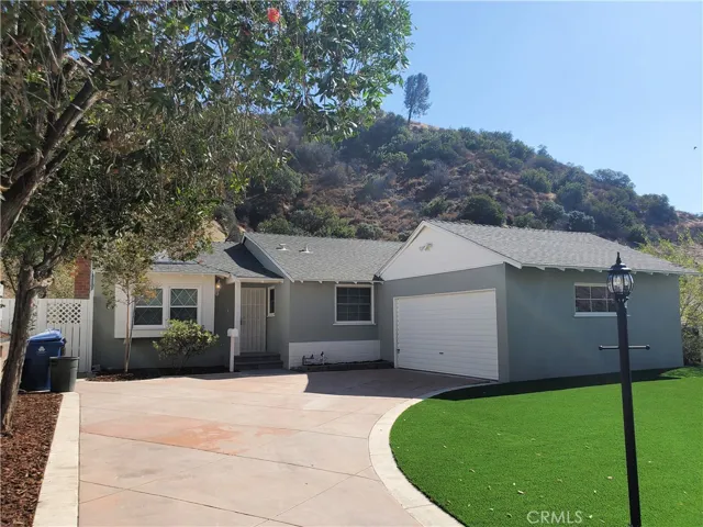 Lovely curb appeal. New artificial grass
