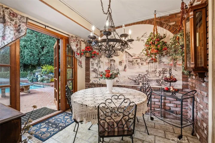 Eating area off of kitchen. French doors leading to patio and pool