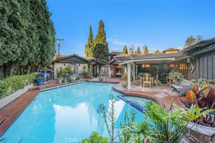 View of pool, pool house, patio and guest quarters.