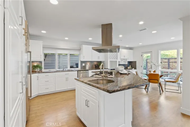 Kitchen island and eating area in background