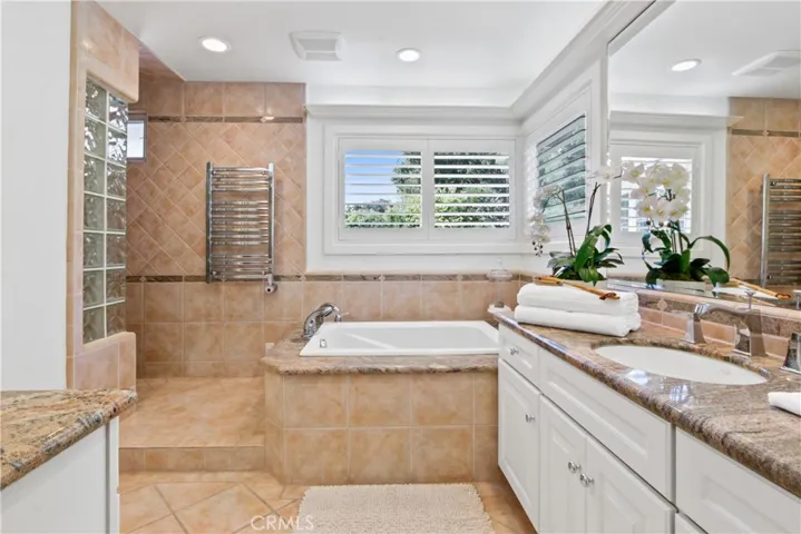 Updated bathroom with soaking tub and separate walk-in shower with towel warmer