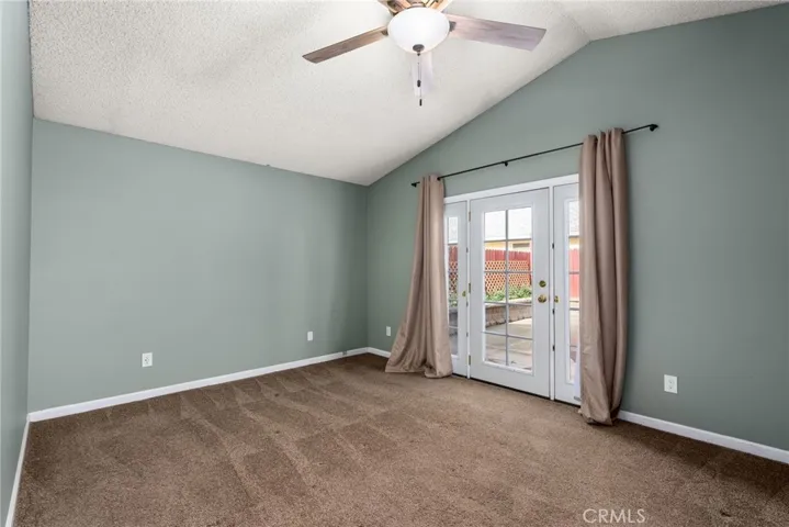 Primary bedroom with french door to rear yard