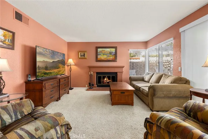 Separate family with cozy fireplace with mantle and hearth