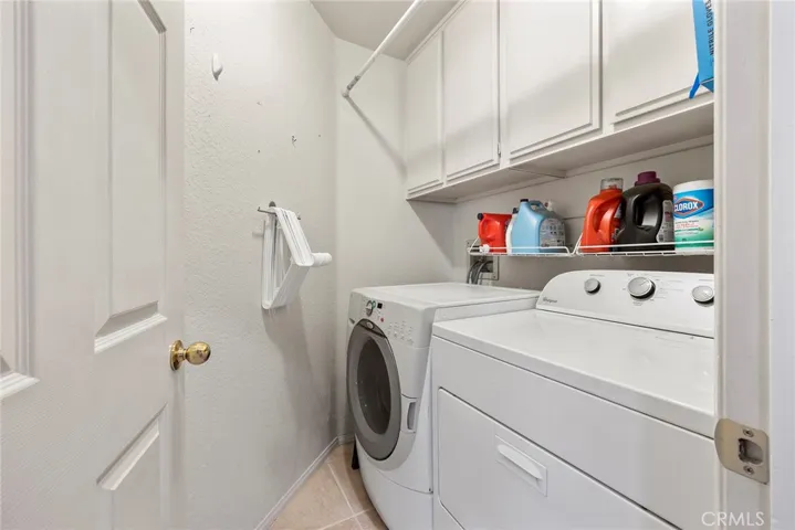 Main floor laundry room with cabinets