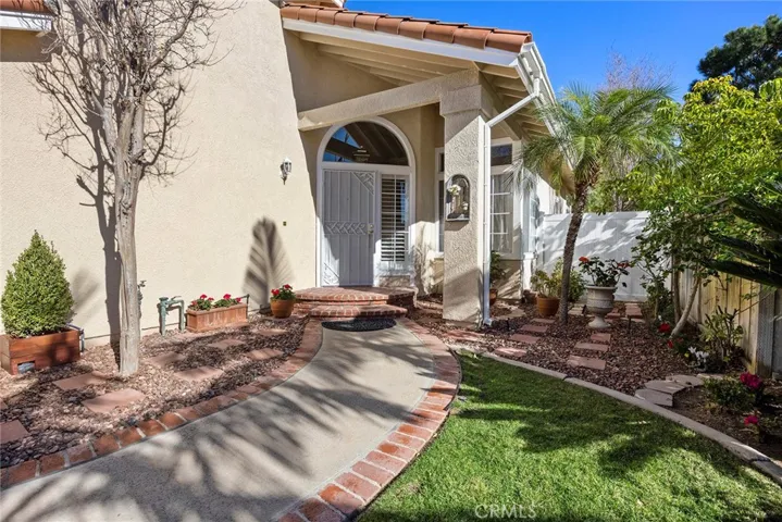 Charming front walkway with security screen door.