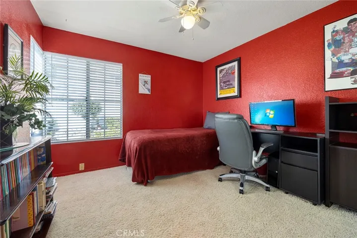 4th bedroom with mirrored closet and fan.