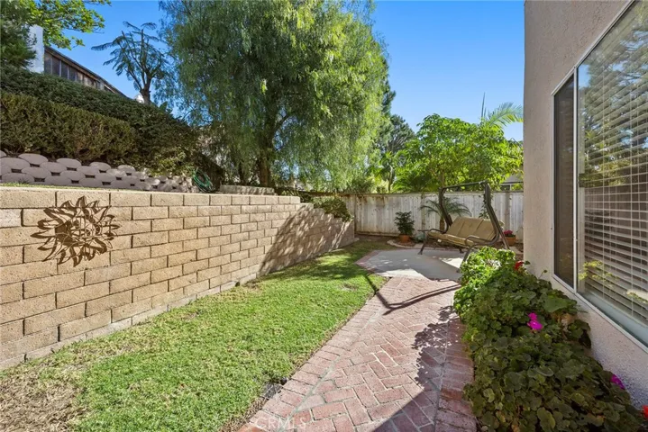Enjoy plenty of seating areas in this well maintained low maintenance landscaped backyard.
