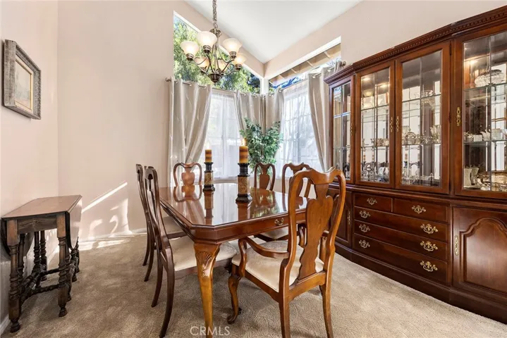 Formal dining room with vaulted ceilings of kitchen