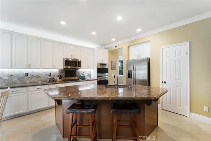 The gourmet kitchen offers a huge center island, walk in pantry and newer appliances!