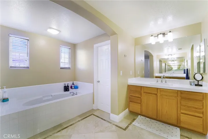 Soaking tub, separate shower, privacy door and dual sinks offer lots of space.