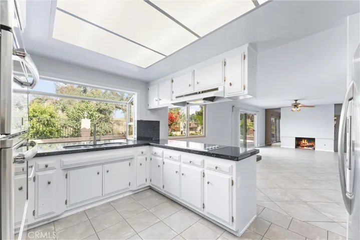 Kitchen has stainless steel appliances and a fabulous view overlooking the pool and hills.