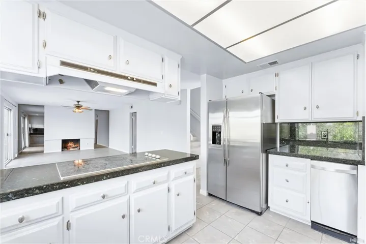 Cooktop and stainless steel refrigerator.
