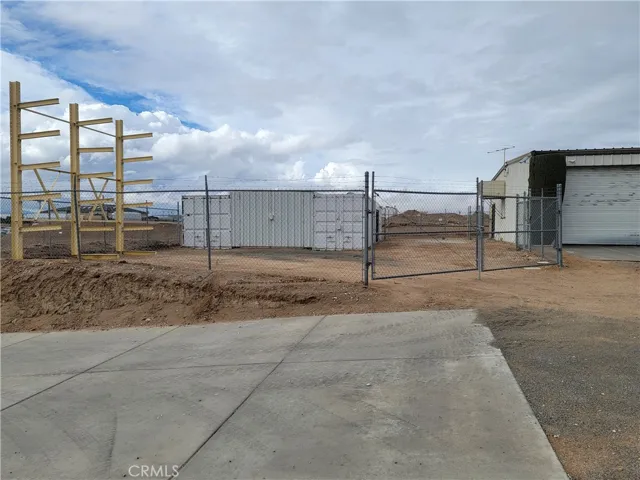 Storage area and driveway to the lower yard.