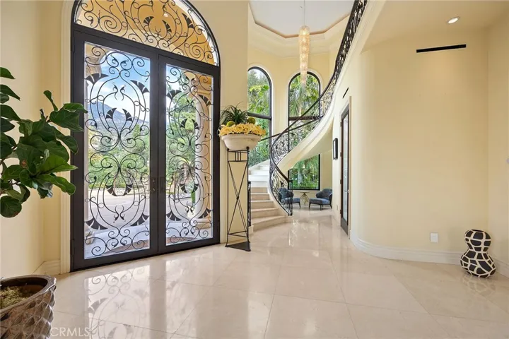 Entryway with tall ceilings, marble flooring, a custom freestanding curved staircase with many more designer elements are sure to impress your guests. Linear AC registers throughout the main level.