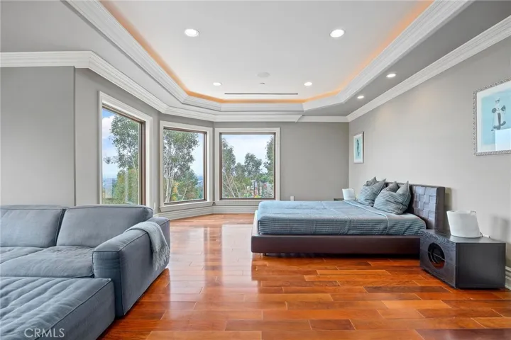 Spacious primary bedroom with a private balcony, amazing views and sitting room.
