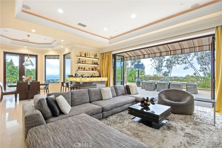 Open floorpan for main living room with bi fold doors, and easy access to the wrap around patio. Kitchen table that easily seats eight between living room and kitchen.