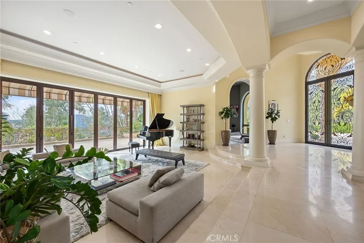 Bifold doors open all the way, showcasing the gorgeous view outside the formal living room.