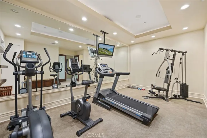 Spacious gym with lots of mirrors. Equipment is included.