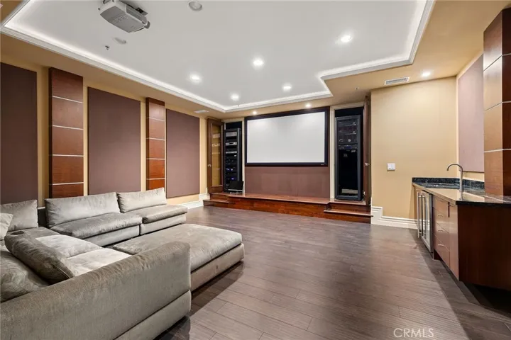 Spacious theater with wet bar, sound panels and a stage