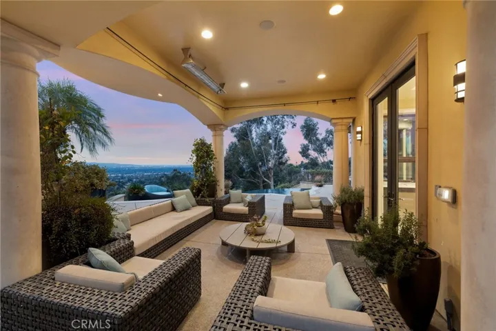 Covered patio with heater and rods for curtains.