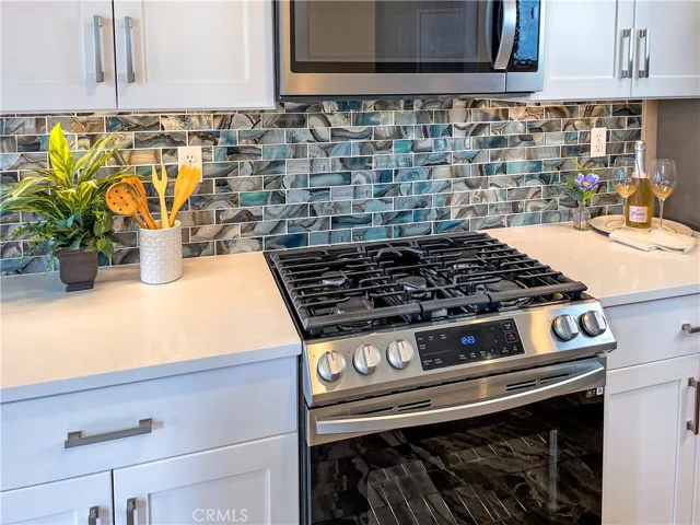 Remodeled Kitchen: Quartz Countertops, Shaker Cabinets, stainless steel appliances, and more.