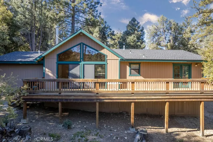 The rear deck faces the trees and the views.