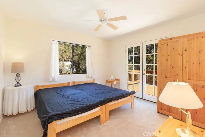 The primary bedroom has French doors to the deck and a private en suite bathroom.