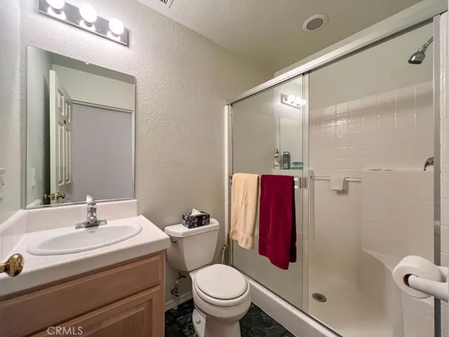 This guest bath is accessed from the hallway and features a large shower.