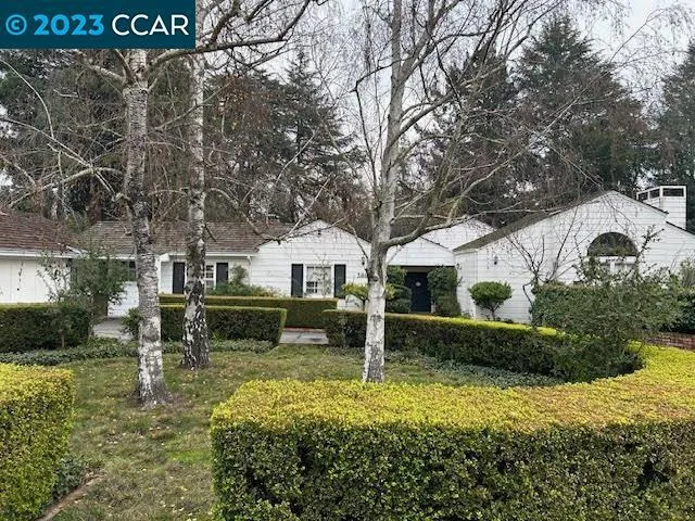 Front of home with circular driveway.