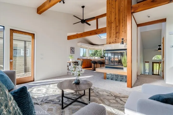 Showing living room, looking at kitchen and front door.