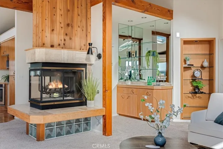 Closer view of fireplace and wet bar.