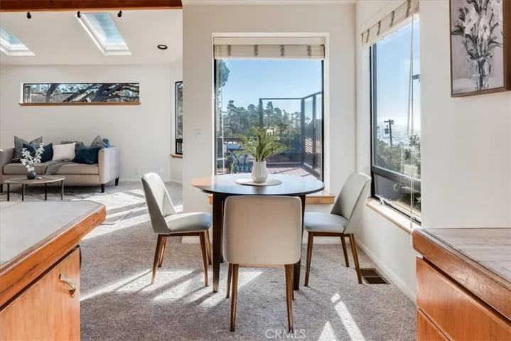 Showing dining area, living room and deck from kitchen.