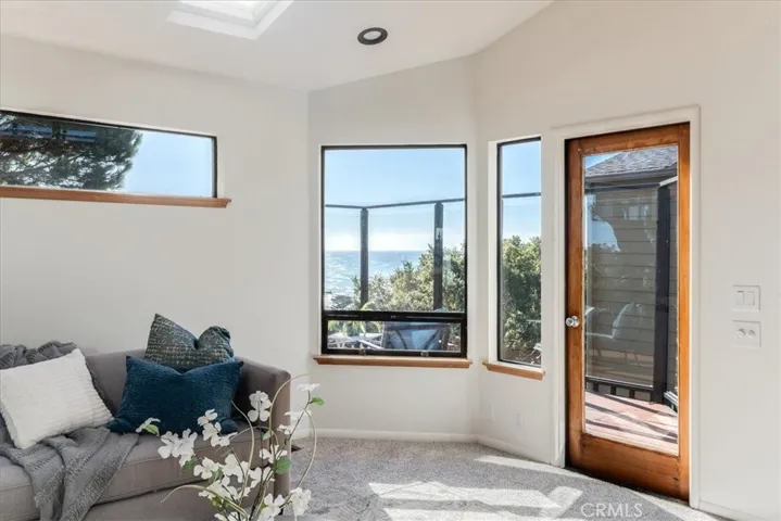 Right side of living room showing door to deck.