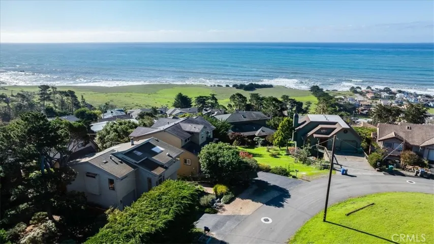 Other photo of home and street from drone. Property for sale is on left corner.
