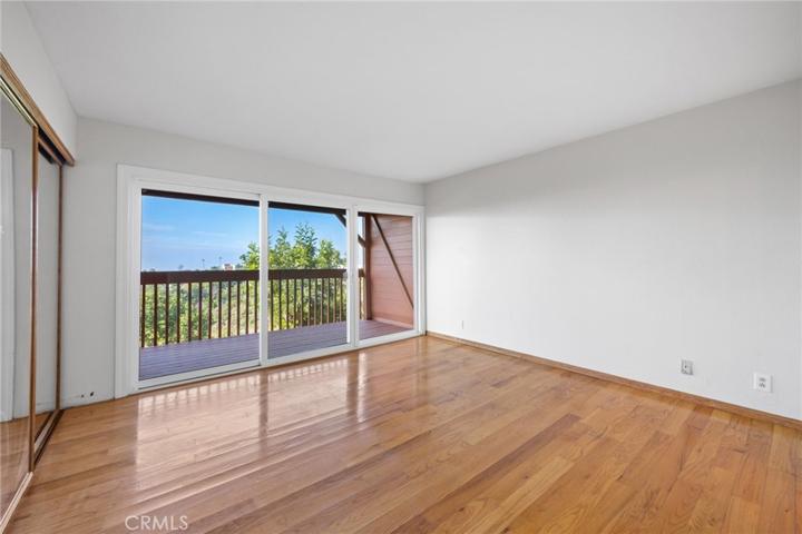 Primary Bedroom with a deck to enjoy the iews of the Pacific Ocean, Catalina Island and the canyon.