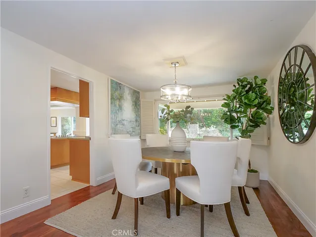 Dining room with big picture window overlooking beautifully landscaped backyard