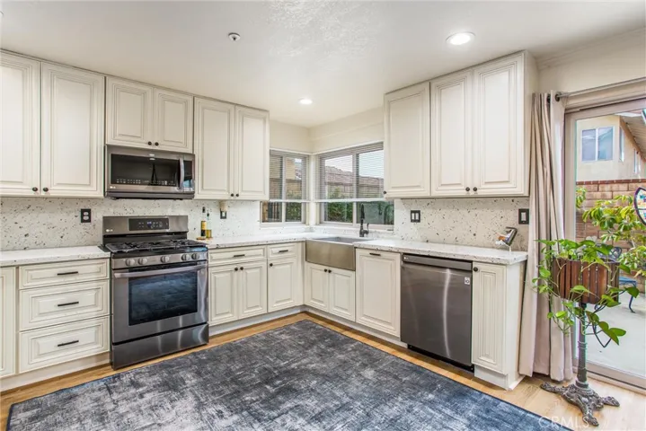 Upgraded kitchen with newer appliances, quartz counters, soft close cabinets and pull out drawers