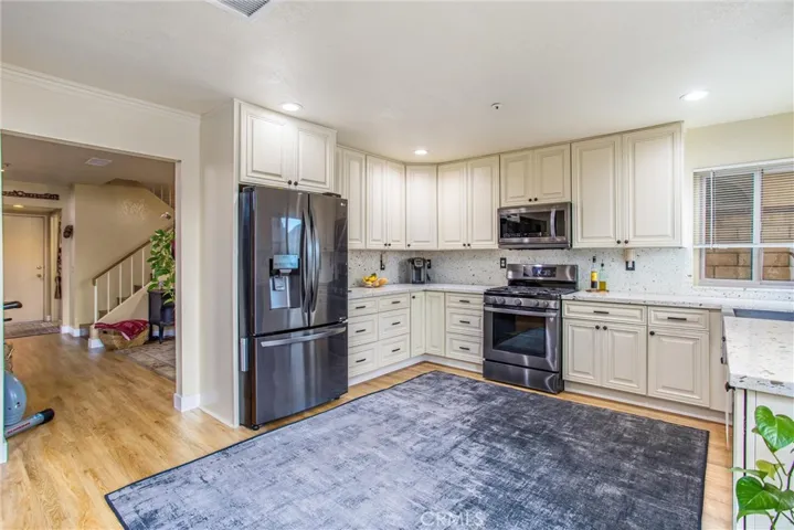 Upgraded kitchen with newer appliances, quartz counters, soft close cabinets and pull out drawers