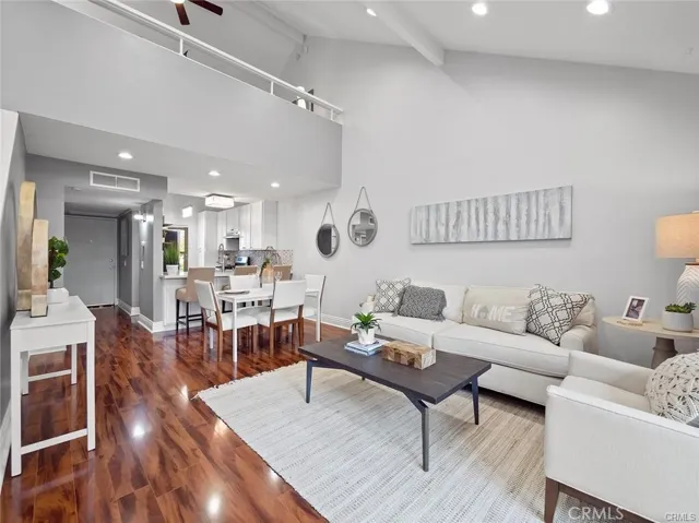 Beautifully upgraded condo with vaulted ceilings, laminate flooring, carpet, recessed lighting, dual pane windows