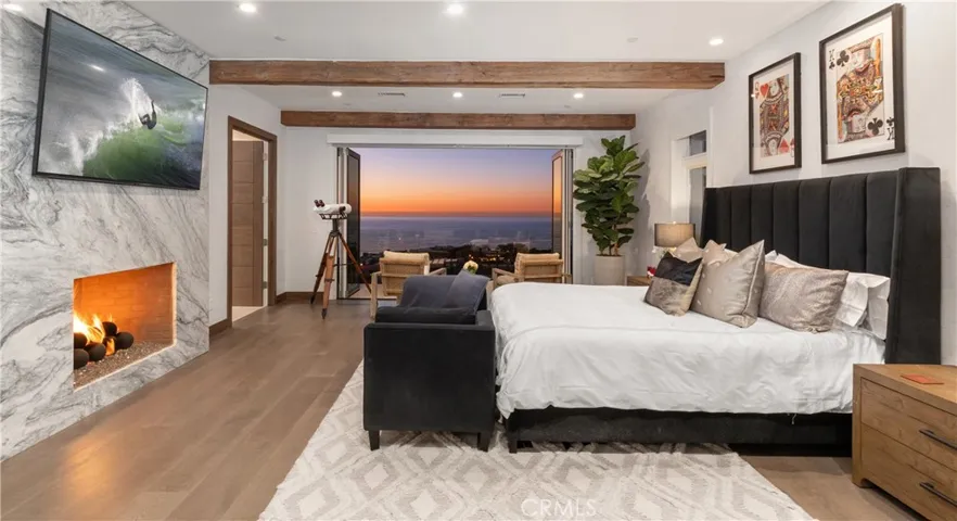 primary suite with fireplace and walk out terrace.