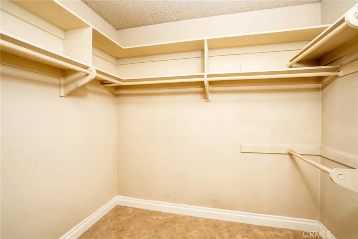 Walk in closet in primary bedroom.