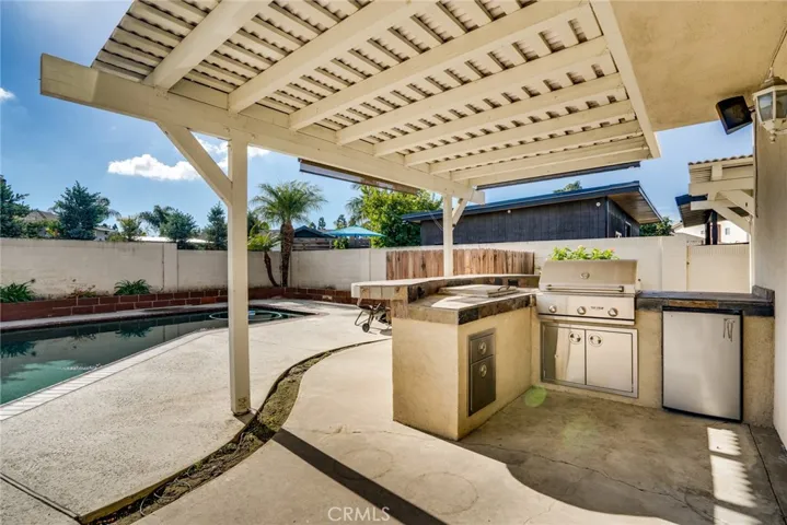 Backyard has built in BBQ, built in refrigerator, counter top ice cooler, and covered patio.